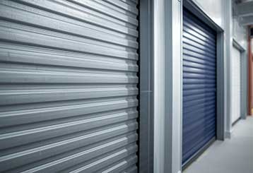 Close-up view of steel and colored roll up garage doors in a modern residential setting