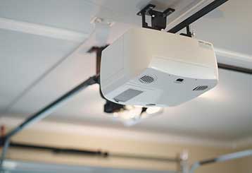 Close-up of a garage door opener system being serviced in a bright, modern Anaheim garage