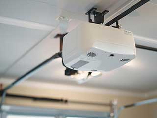 Close-up of a garage door opener system being serviced in a bright, modern Anaheim garage
