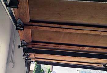 Close-up of severely rusted and worn garage door roller before replacement Fullerton, CA