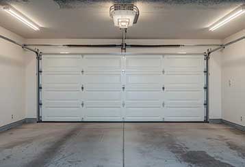 Modern double garage door in a spotless, brightly lit Anaheim garage after expert servicing