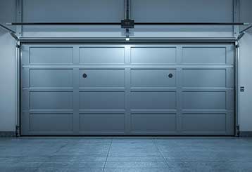 Sleek sectional garage door newly installed inside a bright, clean Anaheim garage, showcasing expert local installation