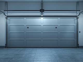 Sleek sectional garage door newly installed inside a bright, clean Anaheim garage, showcasing expert local installation