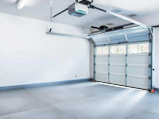 Technician servicing a Sears garage door opener mechanism inside an Anaheim home garage